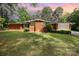 Charming single-story brick home featuring a well-manicured lawn and mature trees at 1012 Hawkinstown Rd, Salisbury, NC 28144