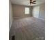 Spacious carpeted bedroom featuring neutral paint, natural light, and modern ceiling fan at 107 Plumtree Dr, Kings Mountain, NC 28086