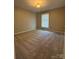 Spacious bedroom featuring neutral paint, natural light, and carpeted floor at 107 Plumtree Dr, Kings Mountain, NC 28086