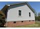Close-up on the house exterior featuring horizontal vinyl siding over a classic brick foundation at 107 Plumtree Dr, Kings Mountain, NC 28086