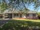 Charming single-story home featuring a well-manicured lawn, front porch, and convenient carport at 107 Plumtree Dr, Kings Mountain, NC 28086
