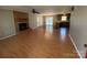 Spacious living room featuring beautiful floors, a brick fireplace, and an open transition to the kitchen at 107 Plumtree Dr, Kings Mountain, NC 28086