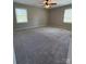 A spacious main bedroom featuring plush carpeting and large windows for plenty of natural light at 107 Plumtree Dr, Kings Mountain, NC 28086