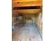 Interior view of shed features open beams, storage shelving, and a plywood floor at 107 Plumtree Dr, Kings Mountain, NC 28086