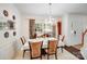 Dining room offers seating for six, a chandelier, and window with floral curtains at 10803 Gold Pan Rd, Charlotte, NC 28215