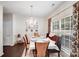 Dining room features a large window with curtains, elegant chairs and chandelier at 10803 Gold Pan Rd, Charlotte, NC 28215