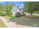 Charming two-story home with vinyl siding and lush landscaping at 10803 Gold Pan Rd, Charlotte, NC 28215