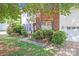 Charming brick home with manicured bushes, front yard, and attached garage at 10803 Gold Pan Rd, Charlotte, NC 28215