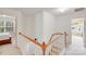 Open hallway with white railings, carpet and views to other rooms at 10803 Gold Pan Rd, Charlotte, NC 28215