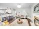 Open-concept living room showcases barstool seating, a fireplace, and a plush sofa at 10803 Gold Pan Rd, Charlotte, NC 28215