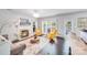 Open-concept living room includes a fireplace, lots of natural light, and yellow chairs at 10803 Gold Pan Rd, Charlotte, NC 28215