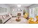 Living room with a fireplace, large decorative mirror, plush sofa, and a patterned rug at 10803 Gold Pan Rd, Charlotte, NC 28215