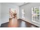 Spacious living room featuring hardwood floors and large windows offering natural light and open floorplan at 10803 Gold Pan Rd, Charlotte, NC 28215