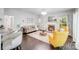 Spacious living room featuring a fireplace, sofa, and barstool seating near the kitchen at 10803 Gold Pan Rd, Charlotte, NC 28215