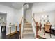 Interior shot of the staircase with carpeted steps and hardwood floors into dining room at 10803 Gold Pan Rd, Charlotte, NC 28215