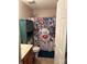 Bright bathroom features a charming cabinet and a unique butterfly shower curtain at 1104 Valley St, Statesville, NC 28677