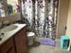 Well-lit bathroom with a modern vanity and sink and a leafy shower curtain at 1104 Valley St, Statesville, NC 28677