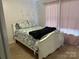 Well-lit bedroom with a decorative comforter and patterned pillows, creating a peaceful retreat at 1104 Valley St, Statesville, NC 28677