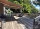 Spacious wooden deck featuring sunshade awning, grill, table, and chairs for outdoor entertainment at 1104 Valley St, Statesville, NC 28677