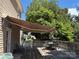 Outdoor deck with an adjustable awning, wood railings, and a patio table with chairs at 1104 Valley St, Statesville, NC 28677