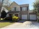 Inviting two-story home with a two car garage, complemented by mature landscaping and a welcoming porch at 1104 Valley St, Statesville, NC 28677