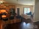 Open concept living room featuring a granite island, black appliances, and hardwood floors at 1104 Valley St, Statesville, NC 28677