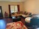 Cozy living room with hardwood floors, a comfortable sectional sofa, and bright natural light at 1104 Valley St, Statesville, NC 28677