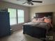 Comfortable bedroom with large windows, a dark wood dresser and a decorative accent pillow at 1104 Valley St, Statesville, NC 28677