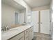 Bright bathroom featuring a double vanity with white cabinets and neutral countertop at 117 Rooster Tail Ln, Troutman, NC 28166