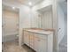 Bright bathroom featuring a double vanity with white cabinets and neutral countertop at 117 Rooster Tail Ln, Troutman, NC 28166