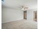 Large bedroom with neutral carpet, fan, and windows for great natural light at 117 Rooster Tail Ln, Troutman, NC 28166