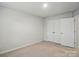 Bedroom with a door, a double-door closet, and neutral walls and carpet, creating a modern space at 117 Rooster Tail Ln, Troutman, NC 28166