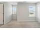 Bedroom featuring neutral carpet, two windows, and a closet providing natural light at 117 Rooster Tail Ln, Troutman, NC 28166