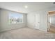 Light-filled bedroom with a window and neutral walls and carpet, creating a warm, inviting space at 117 Rooster Tail Ln, Troutman, NC 28166