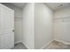 Bright, empty closet features carpet, wire shelving, and a crisp white door at 117 Rooster Tail Ln, Troutman, NC 28166