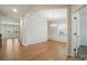 Open concept dining area featuring wood floors, wainscoting details, and natural light at 117 Rooster Tail Ln, Troutman, NC 28166