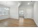 Bright dining area with elegant wainscoting, wood flooring, and modern lighting fixtures at 117 Rooster Tail Ln, Troutman, NC 28166