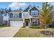 Charming two-story home featuring a two car garage and stone accents on the front facade at 117 Rooster Tail Ln, Troutman, NC 28166