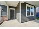 Front porch featuring sleek design elements and a gray color scheme with white trim accents at 117 Rooster Tail Ln, Troutman, NC 28166
