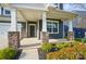Inviting front porch with stone pillar bases, number 117, and well-maintained landscaping at 117 Rooster Tail Ln, Troutman, NC 28166