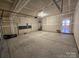 An empty, unfinished garage, primed and ready for personalization and storage solutions at 117 Rooster Tail Ln, Troutman, NC 28166
