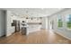 Open concept kitchen with white cabinets, island and stainless steel appliances at 117 Rooster Tail Ln, Troutman, NC 28166