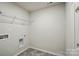 A laundry room featuring connections for a washer and dryer with overhead shelving for storage at 117 Rooster Tail Ln, Troutman, NC 28166