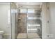 Modern shower stall with a glass enclosure and tile surround and bench at 117 Rooster Tail Ln, Troutman, NC 28166
