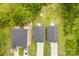 An aerial view captures three homes with gray roofs, white driveways, and cars parked outside at 1301 Marble St, Charlotte, NC 28208
