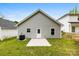 Exterior view of backyard with concrete patio, windows, and white door at 1301 Marble St, Charlotte, NC 28208