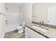 This bathroom has a granite vanity, a white sink, a toilet, and a tiled bathtub with shower at 1301 Marble St, Charlotte, NC 28208