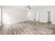 The bright bedroom showcases laminate flooring, neutral walls, and an open doorway leading to additional spaces at 1301 Marble St, Charlotte, NC 28208