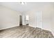Bright bedroom with wood-look flooring, neutral walls, and bathroom access at 1301 Marble St, Charlotte, NC 28208