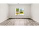 Bright bedroom with wood-look flooring and a window offering neighborhood views at 1301 Marble St, Charlotte, NC 28208